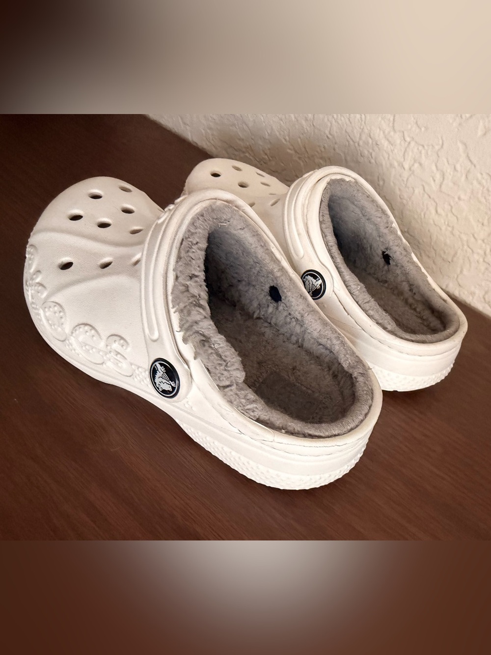 white Crocs Baya Lined Clogs featuring a cozy grey faux-fur lining. C-12